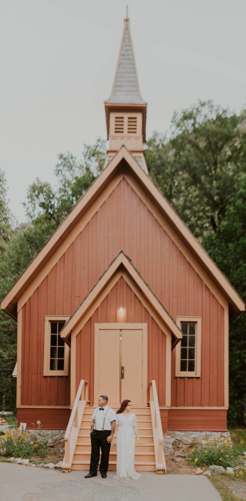 Couple standing outside the Yosemite chapel in Yosemite National Park
