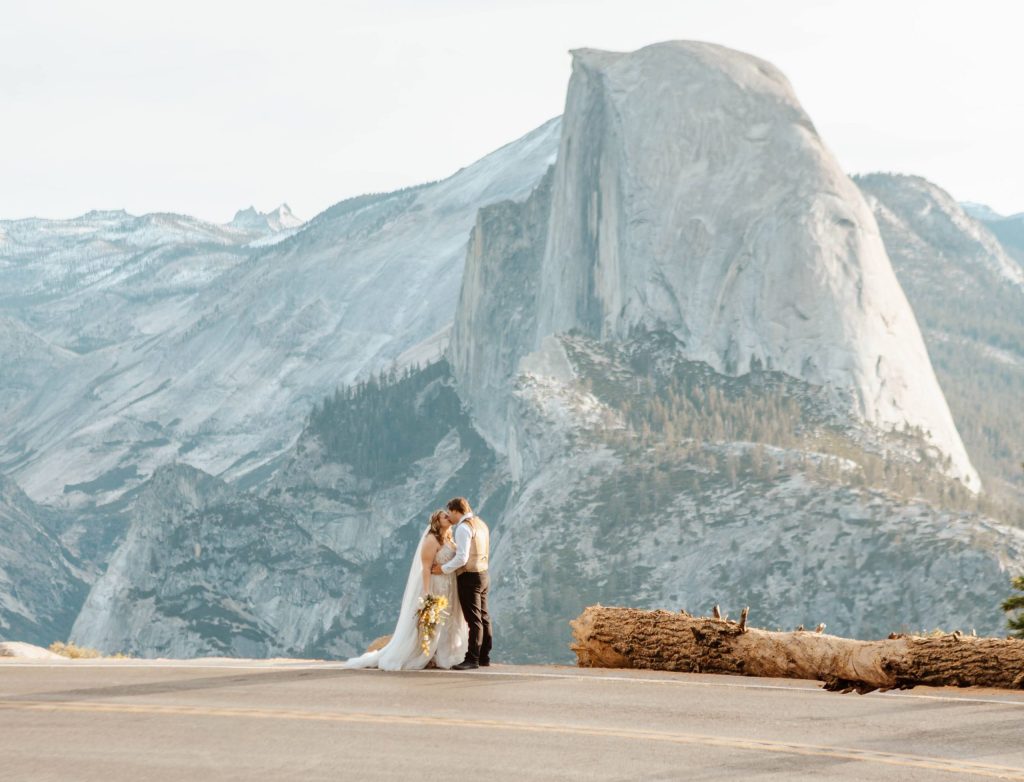 couple eloping at glacier point with half dome as a big presence in the background