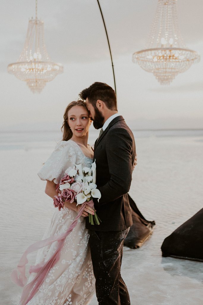 couple elope at the salt flats under some chandeliers. 